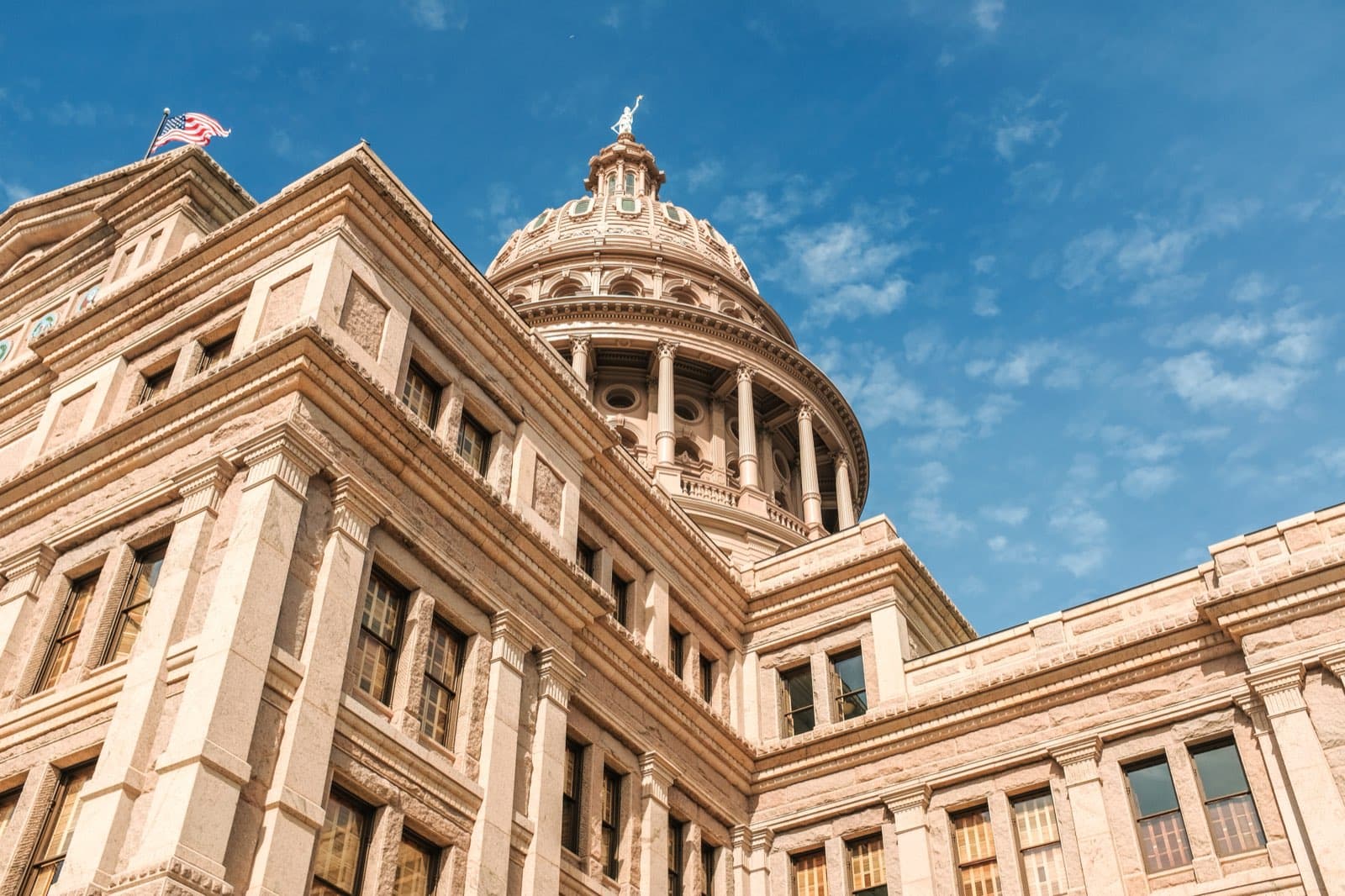 The Texas State Capitol in Austin, seen from below against a blue sky