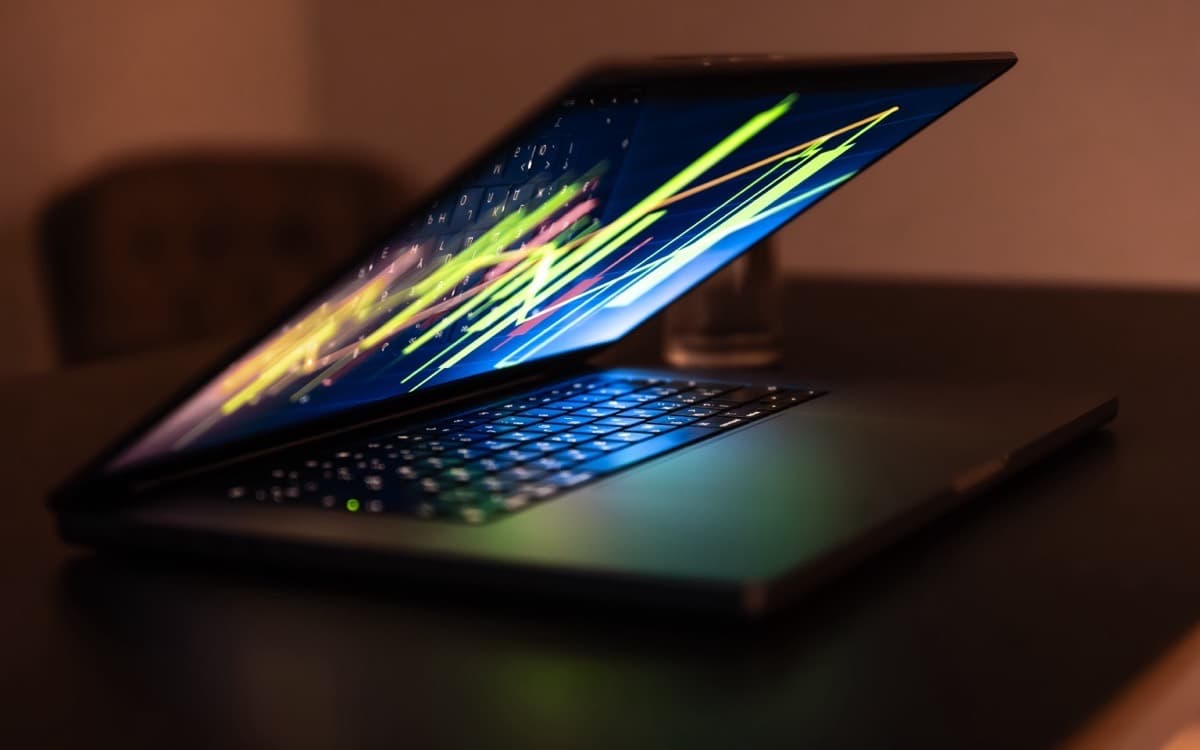 Laptop showing a performance chart on a desk at night